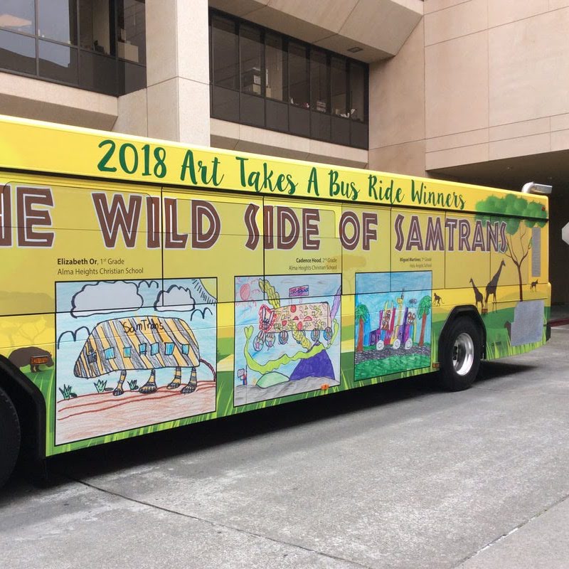A SamTrans bus displays the 2018 Art Takes a Bus Ride winners.